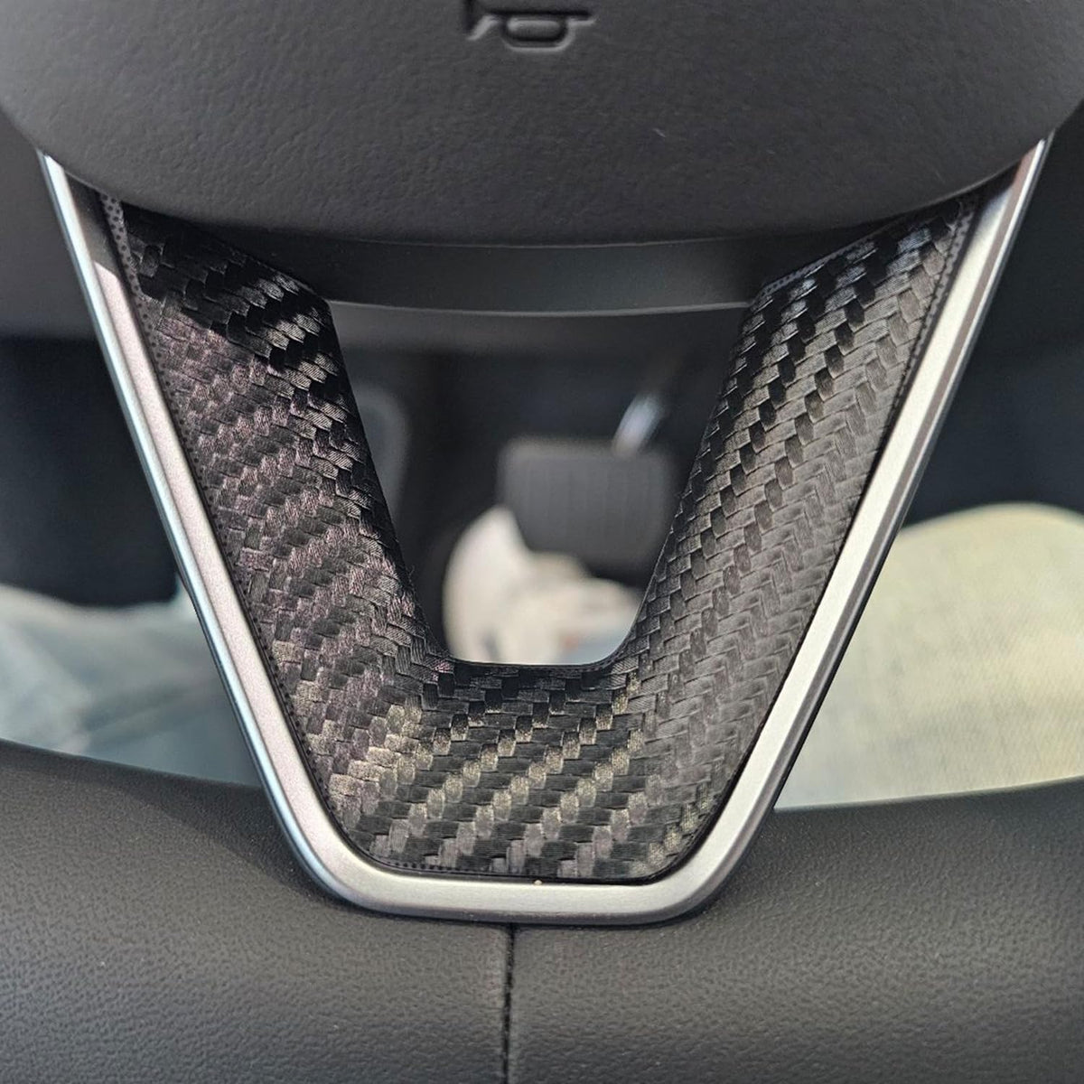 Carbon fiber skin on the lower steering wheel spoke of a Tesla Model Y Juniper